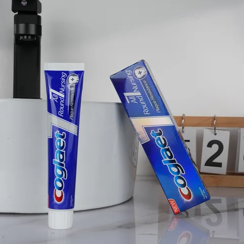 Toothpaste tube with blue and silver retail packaging