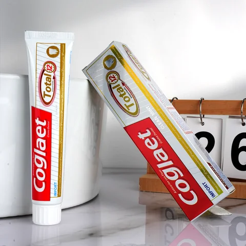 Toothpaste tube with red and gold retail packaging
